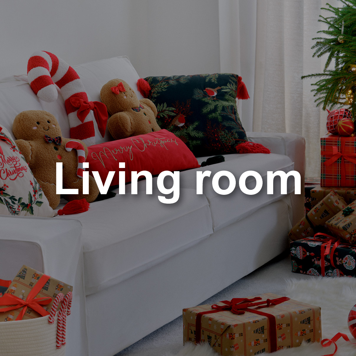 Sofa covered in christmas themed cushions and ginger bread man 