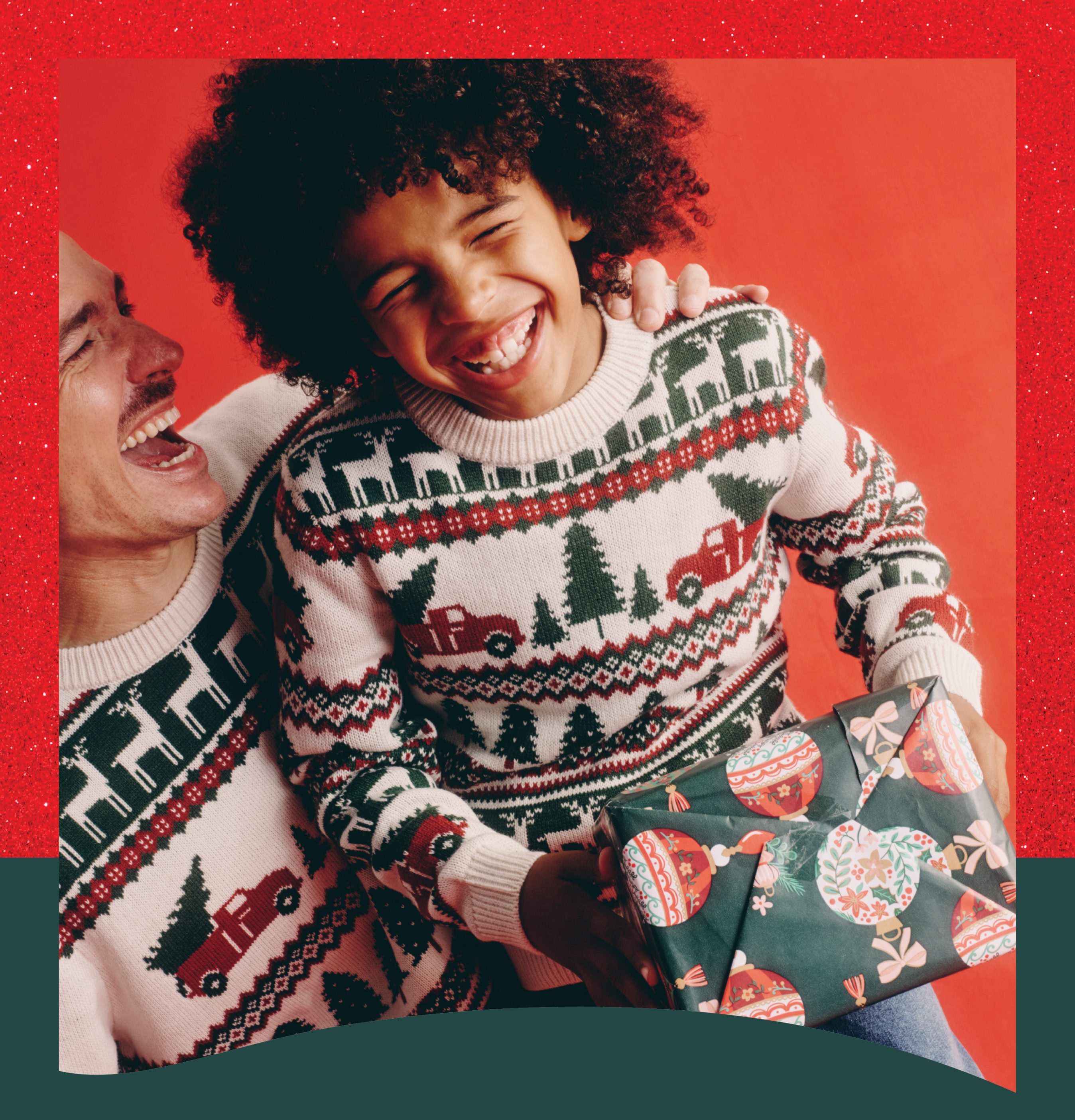 Young boy and man wearing a Christmas jumper 