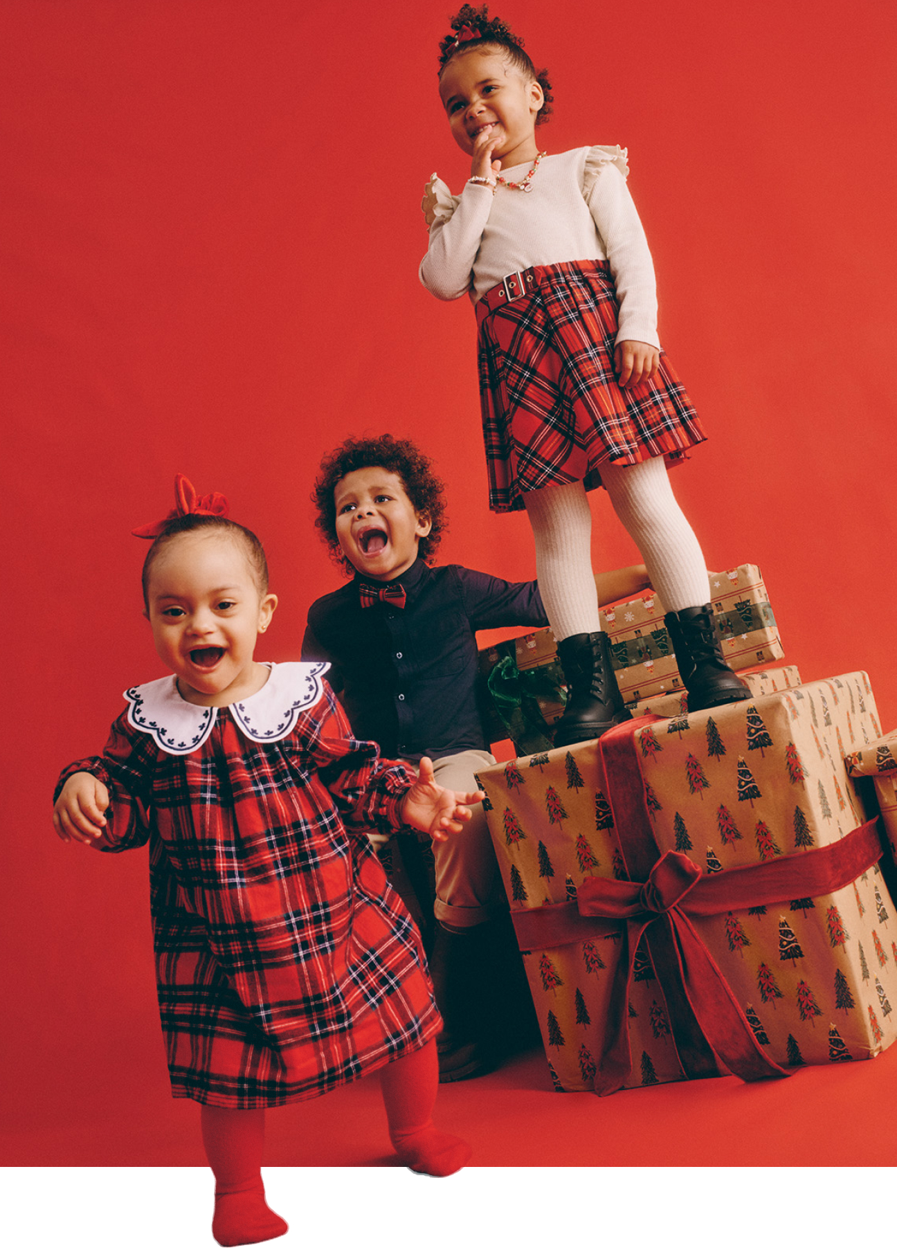 Children wearing Christmas clothing from Primark in a festive background