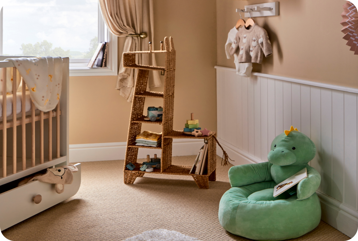 A nursery filled with a baby cot, giraffe storage and a green dinosaur chair 