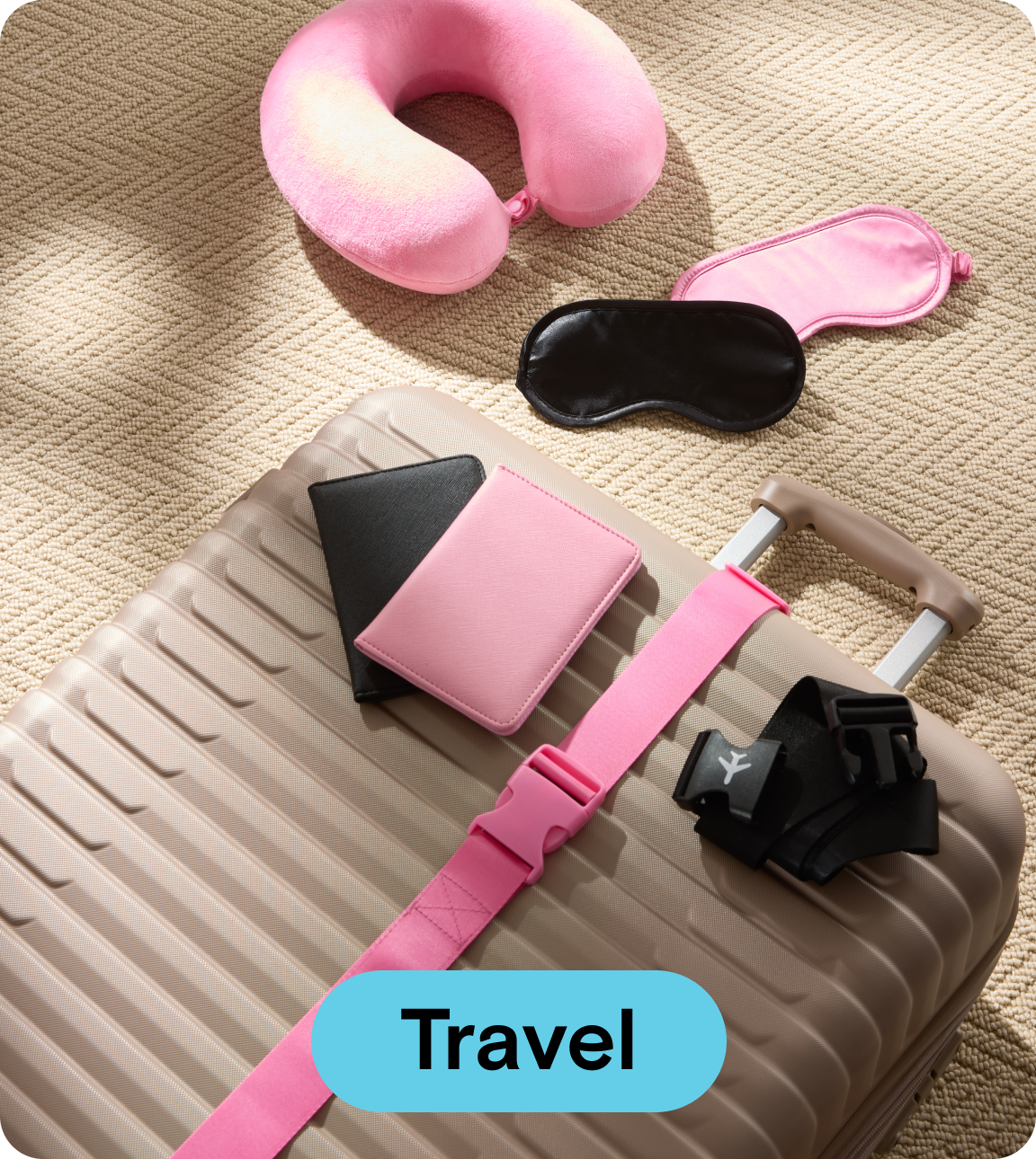 Gold suitcase with pink neck rest and a pink and black passport 