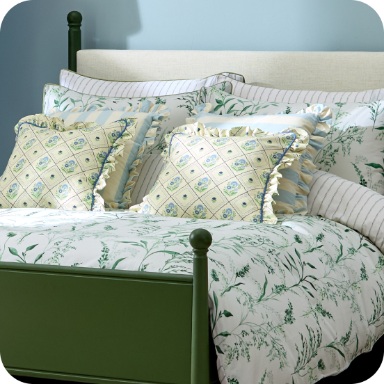 Green and white bed with floral bedding