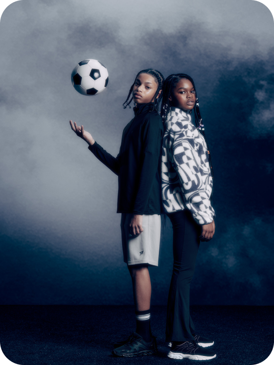 two models wearing black and grey workout set and black and white zip up sweatshirt 