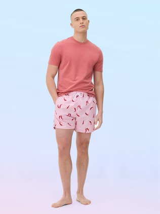 Man wearing a red t-shirt with chilli print beach shorts