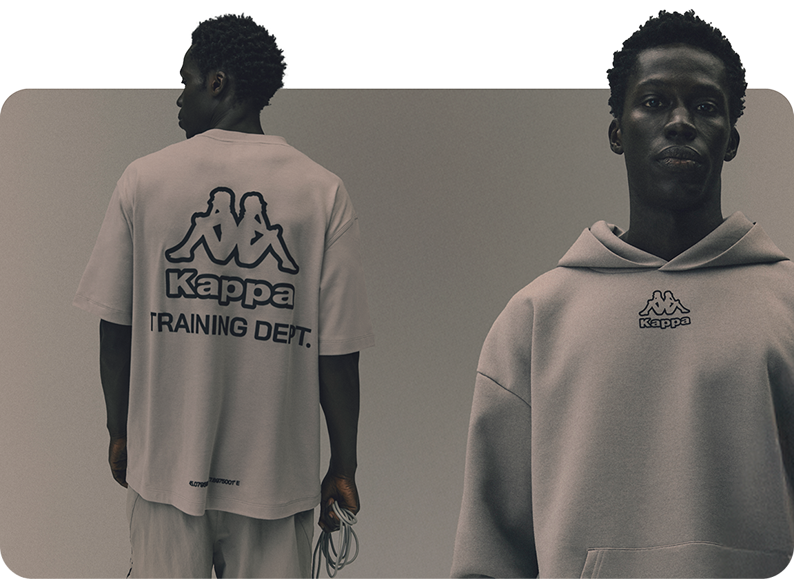 Male model wearing a white tshirt and grey hoodie from the Kappa x Primark collection