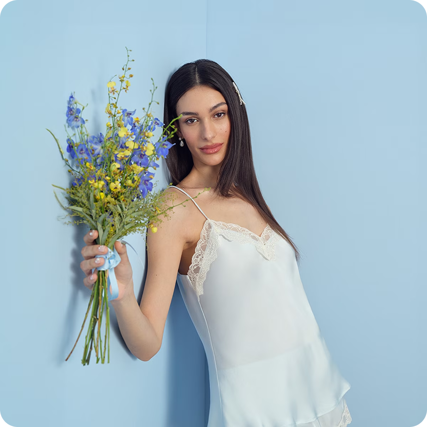 Model wearing white satin PJs