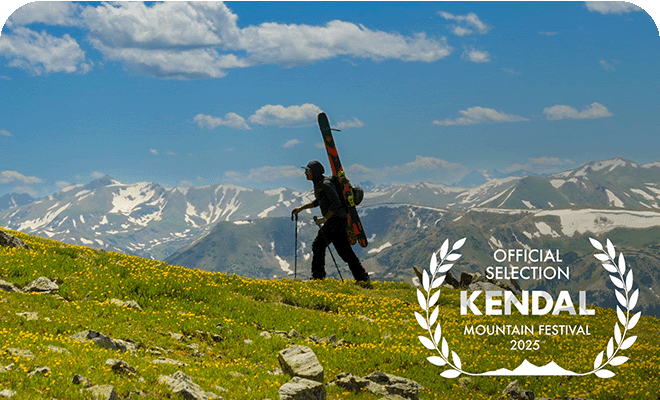 Doug Evans hiking through the mountains with skis on his back - official selection Kendal mountain festival