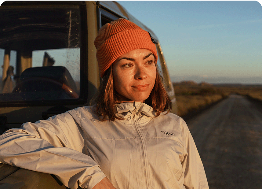 women stood leaning on a truck