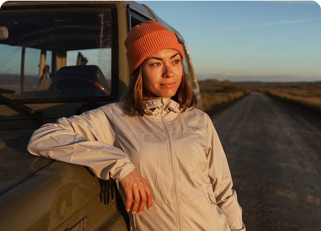 women stood leaning against a truck