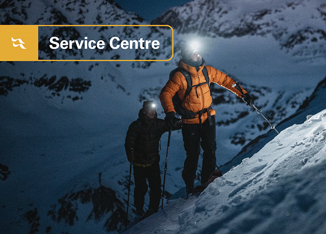 two alpinists hiking up the snowy mountainside.