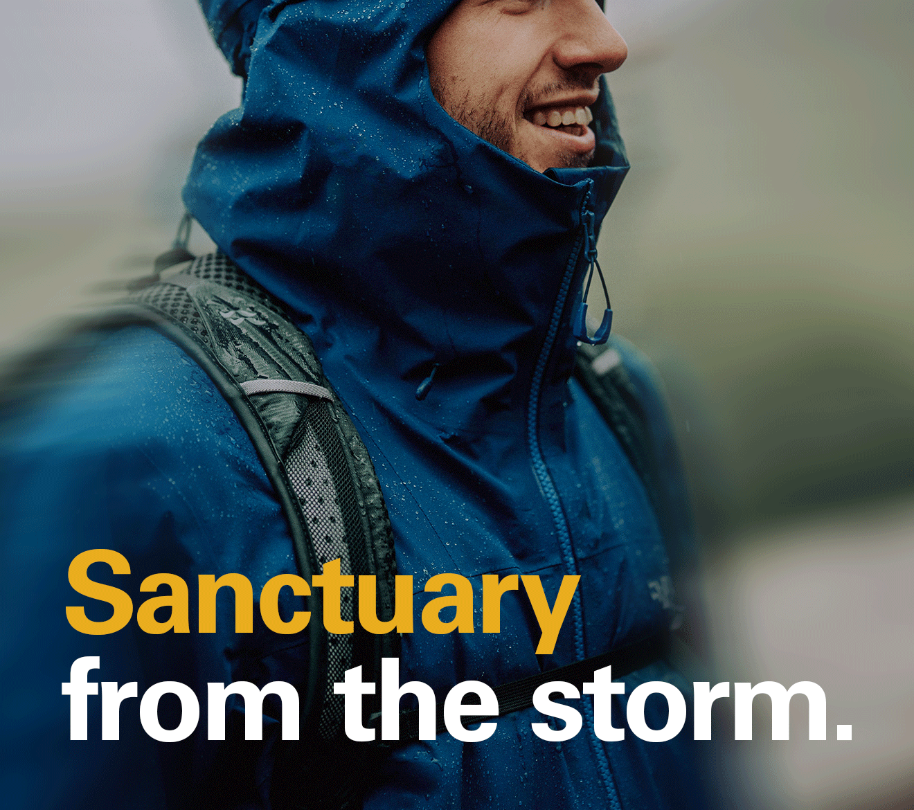 'Sanctuary from the storm.' Copy written oven the image of a man on a hike. He is wearing a waterproof Rab jacket in the rain.