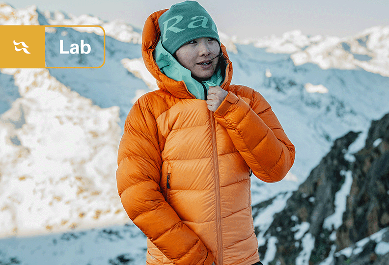 An alpinist wearing a down jacket in the mountains.