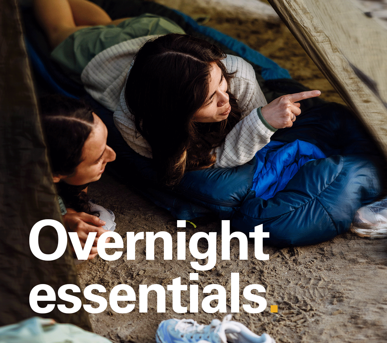 'Overnight essentials' text written over the image of a people set up for a camp enjoying the surroundings.