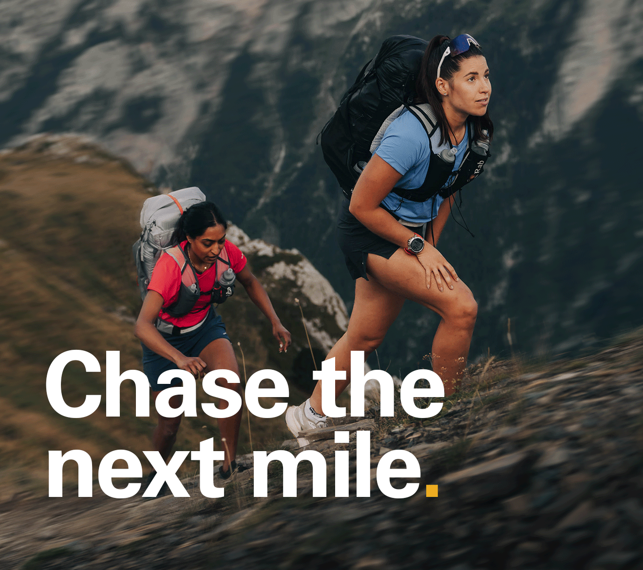 'Chase the next tile' Text of the image of 2 women trail running un in the mountains.