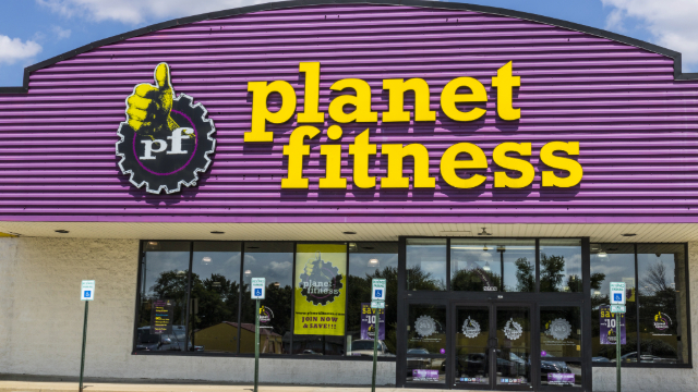 Planet Fitness store front - purple background with yellow lettering. 
