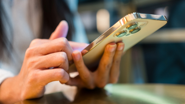 Person holding a smartphone in their hands. 