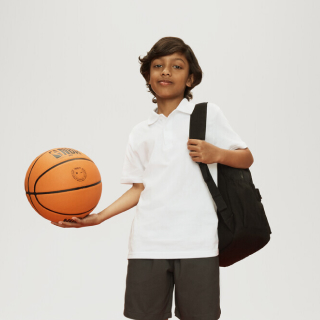 Schoolboy with backpack and basketball