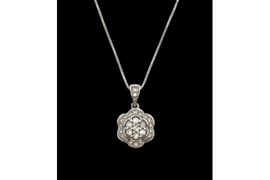 A Diamond Flower Pendant On A White Gold Box 17