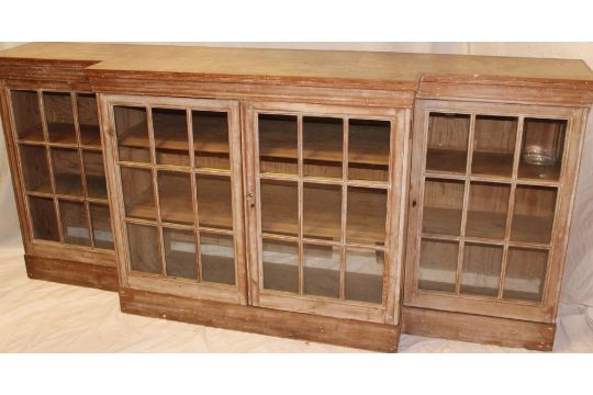 A polished pine break-front bookcase