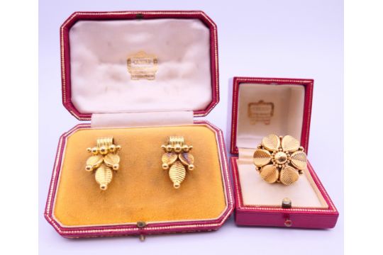 A boxed unmarked gold Cartier ring and a pair of earrings