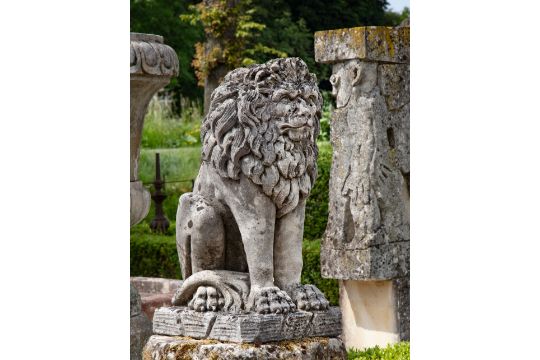 A Sculpted Limestone Model Of A Seated Lion
