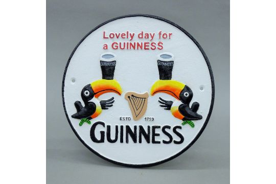 A cast metal 'Guinness' sign. 25.5 cm diameter.