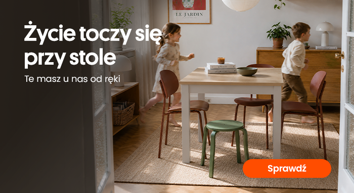 Playful children running around a modern dining table in a sunlit family dining room with mixed chairs, rug and warm home decor