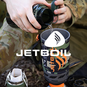 an image of a man pouring water into a cup from a jetboil