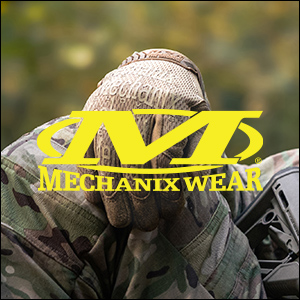 an image of a man in camouflage clothing holding his head