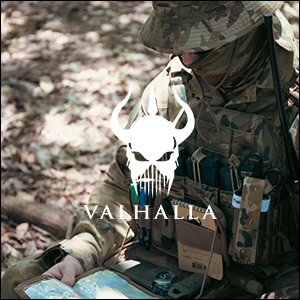 an image of a man in camouflage is using a laptop